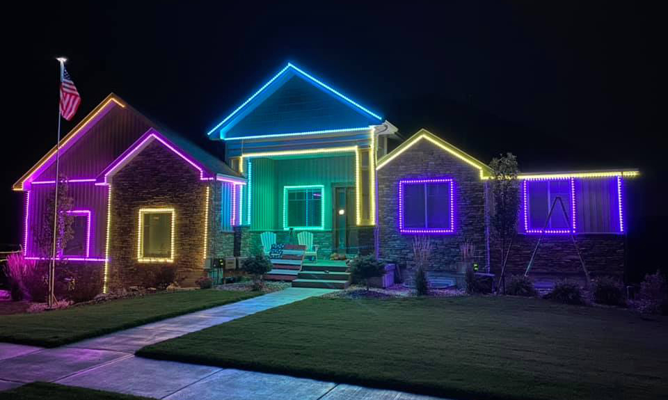 The Robinson family home outlined in blue, purple, yellow, and green lights in 2021.