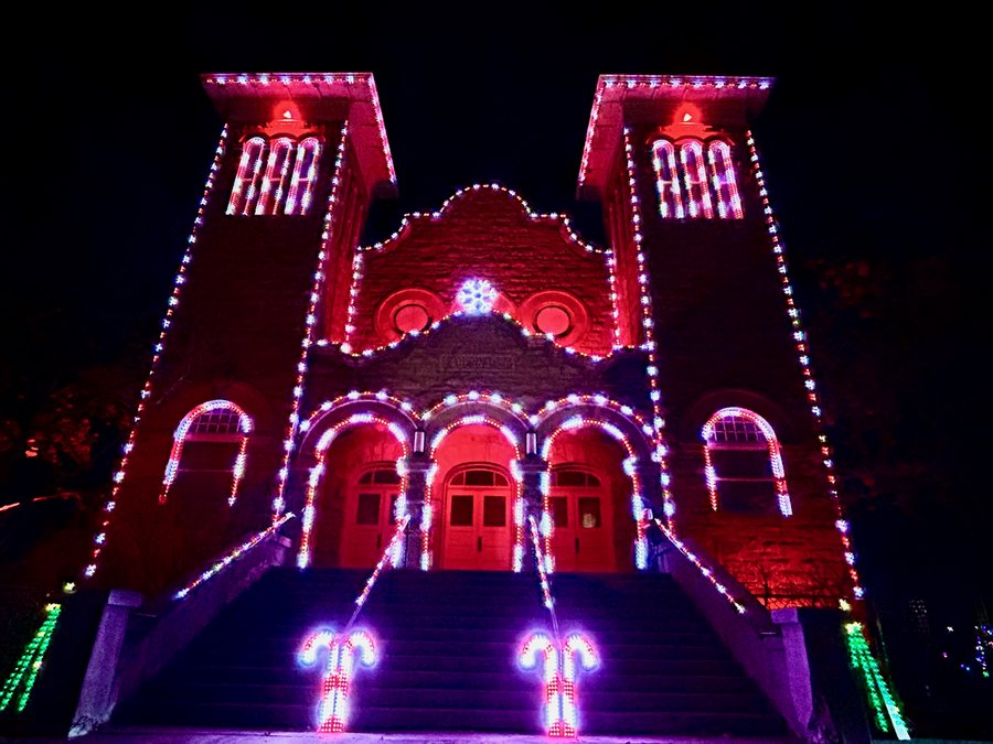 The Tabernacle illuminated in red and white with candy-cane props at the foot of the steps.