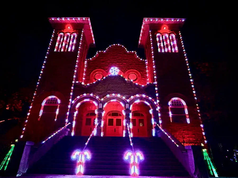 Red-and-white lighting and illuminated candy-cane props transform the Rexburg Tabernacle during the 2023 show.