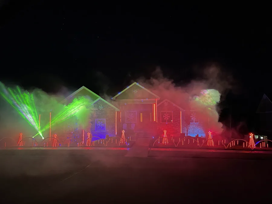 Red and green light, lasers and fog fill the family home during the 2021 Robinson Family Light Show in Rexburg, Idaho.